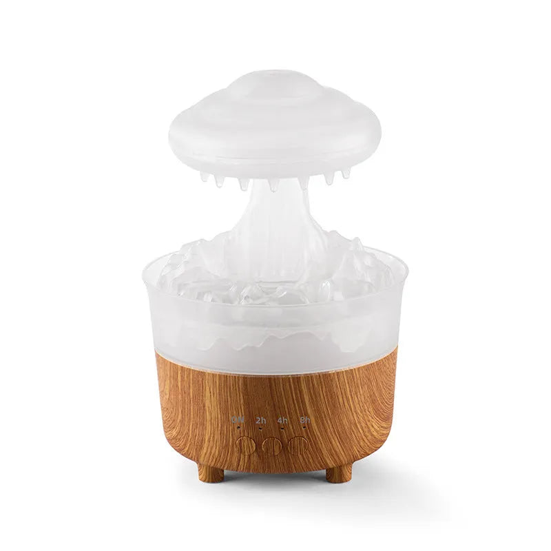 Wood grain white rain cloud shaped humidifier, diffuser, and night light on a table.