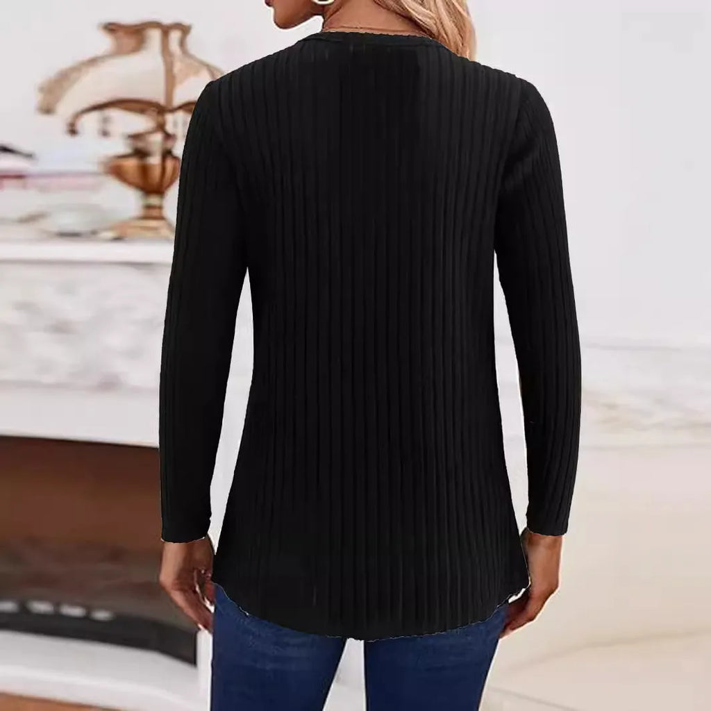 A simple solid colour knitted pullover sweater with button detailing on the front.