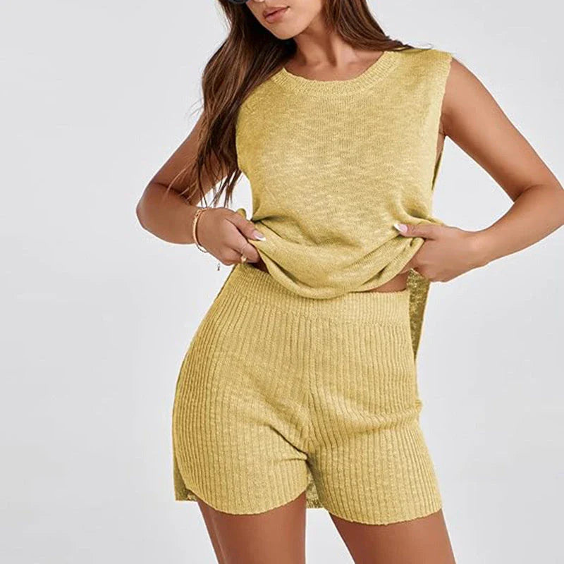 Stylish 2-piece knit romper set in various colors, featuring a split-hem top and matching shorts for a relaxed, modern summer look