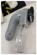 Grey electric pet hair vacuum grooming brush with rubber head and collection canister