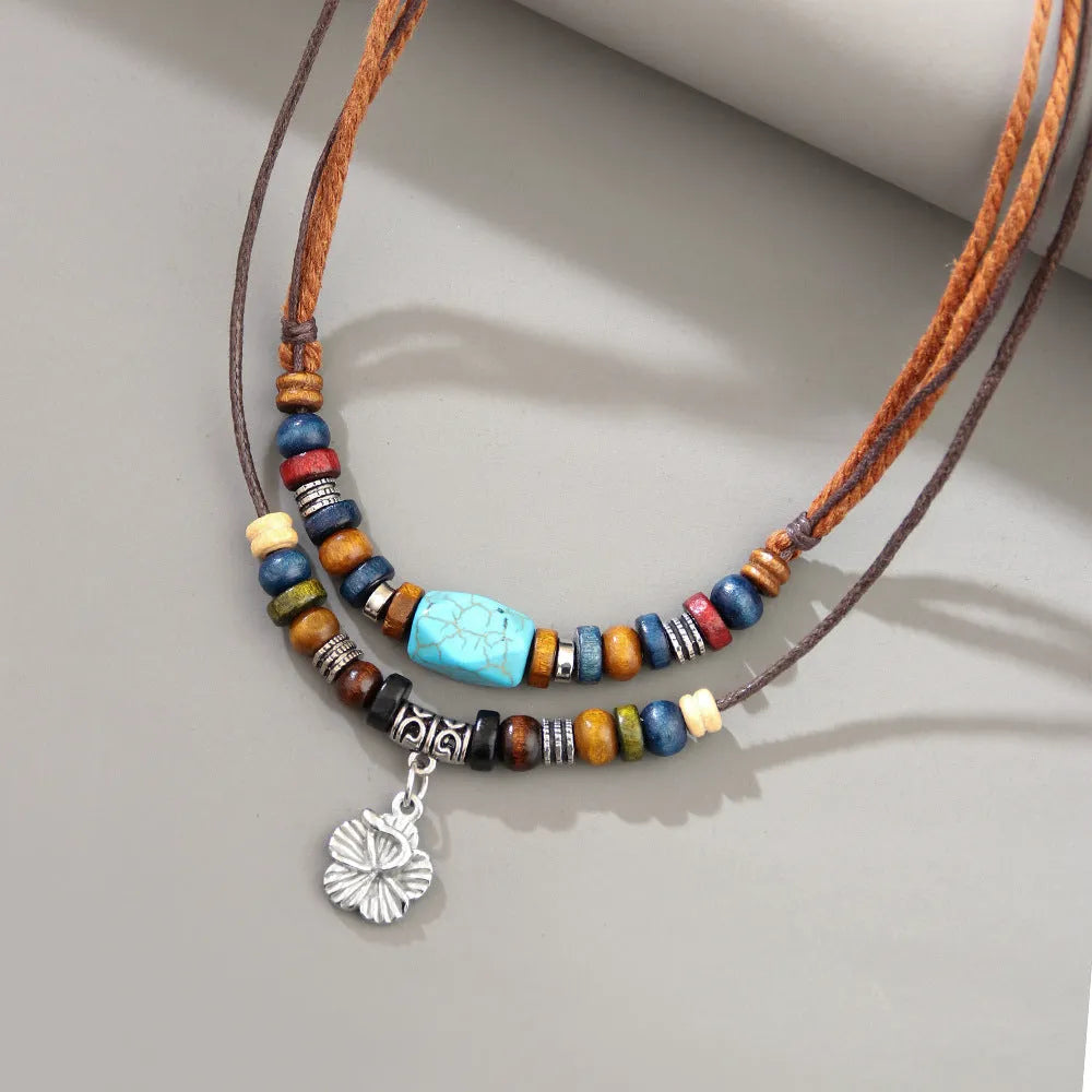 Men's turquoise wooden bead necklace with geometric alloy pendant on cream wax rope