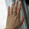 Handmade elastic love ring with geometric beaded string design and heart charm on adjustable band