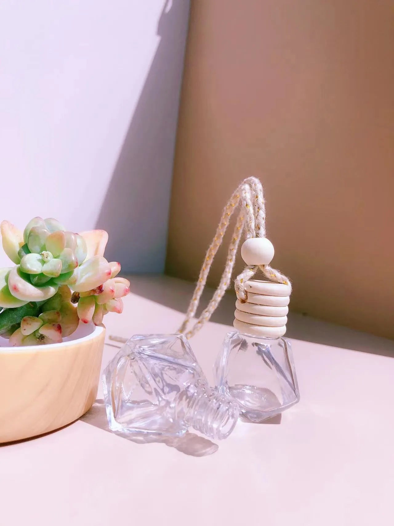 Car perfume pendant in glass bottle showing cylinder, diamond, flat drum and square style options