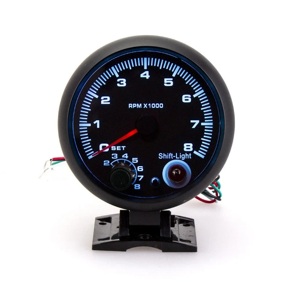 Black plastic automotive tachometer with blue light pointer display showing 0-8000 rpm range