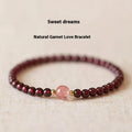 Natural garnet bracelet with U-shaped design showing garnet and dream garnet colour options