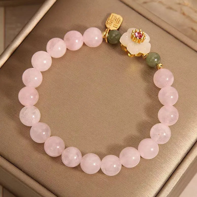 Crystal and Hetian Jade beaded bracelet with peach blossom design and adjustable cord.