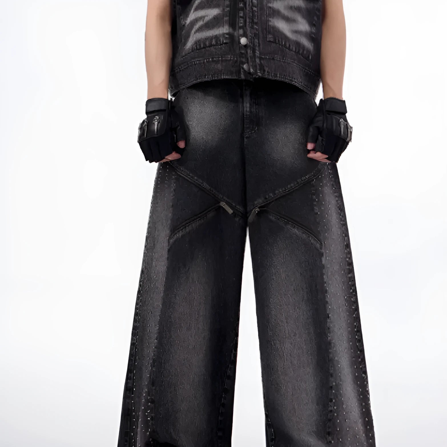 Black and grey washed denim wide leg trousers with structural zipper detail and matching vest, laid flat.
