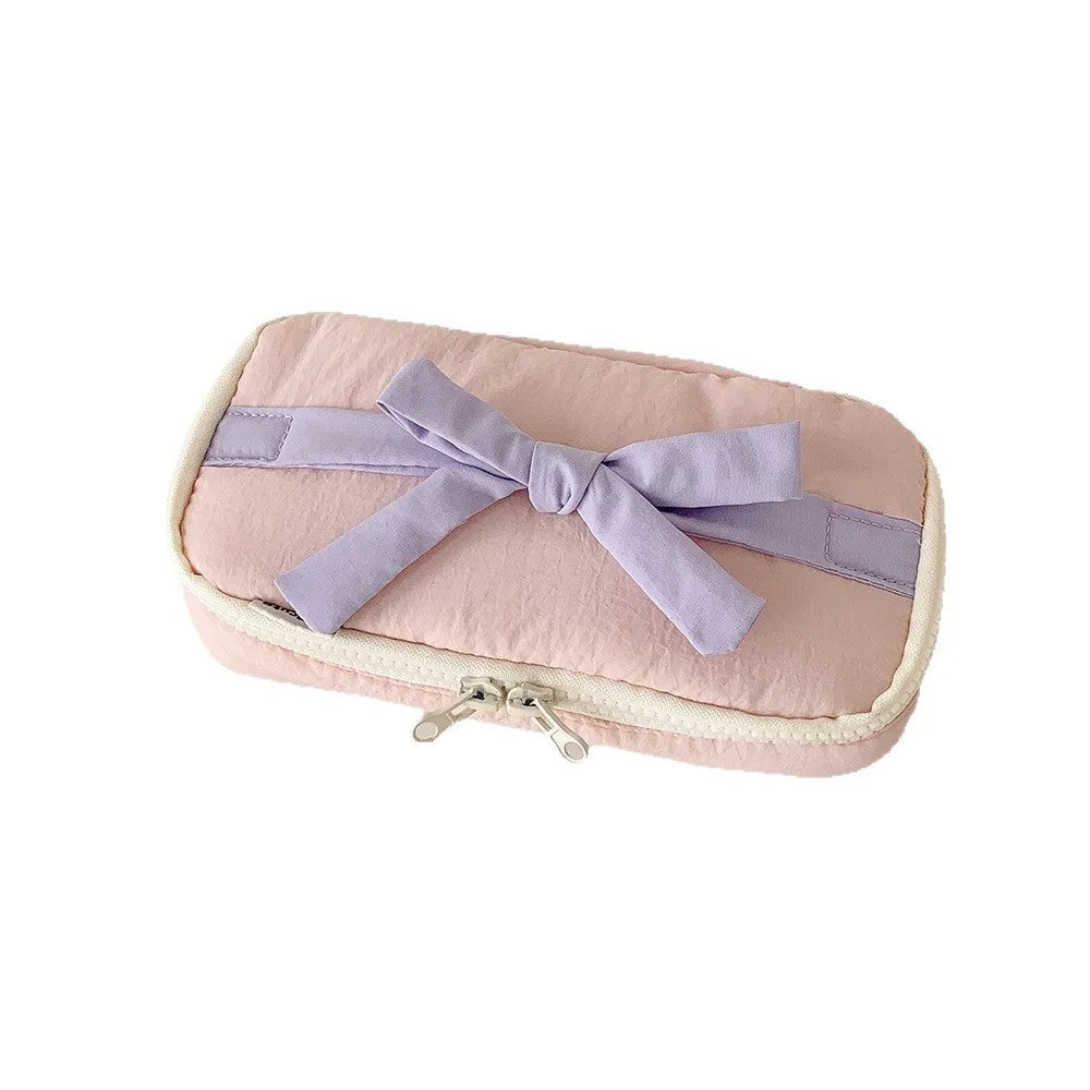 Soft polyester cotton pencil case with minimalist bow design, available in six colours including pink, black and yellow