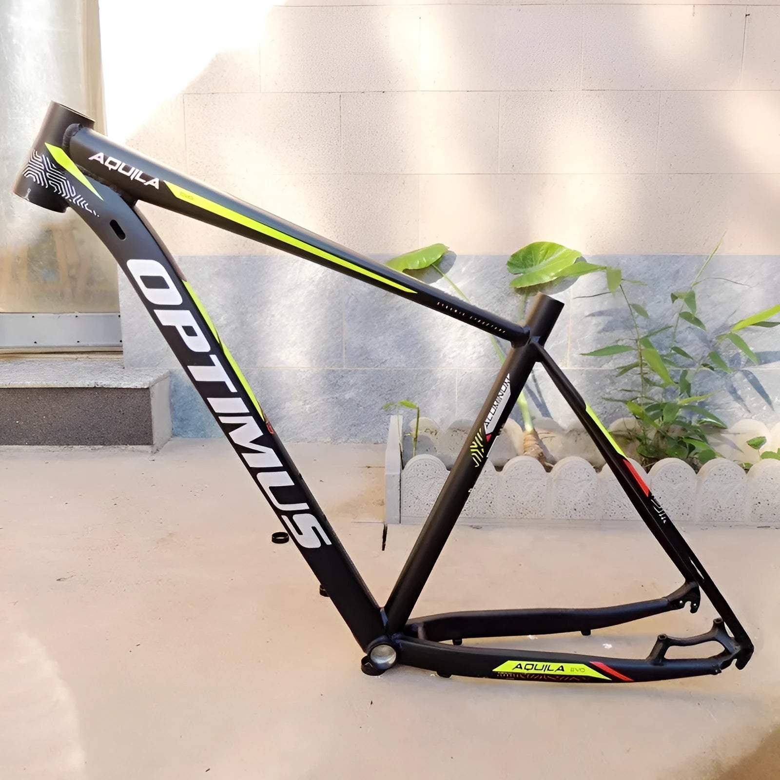 29-inch aluminium mountain bike frame in black green colour with disc brake mounts and internal cable routing
