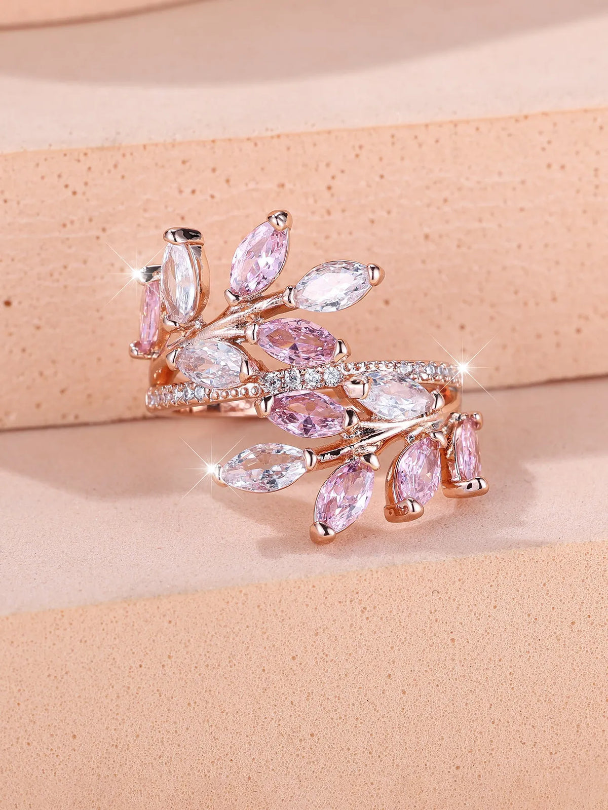 Adjustable copper leaf ring with a horse eye zircon stone in multiple colour finishes on a neutral background.