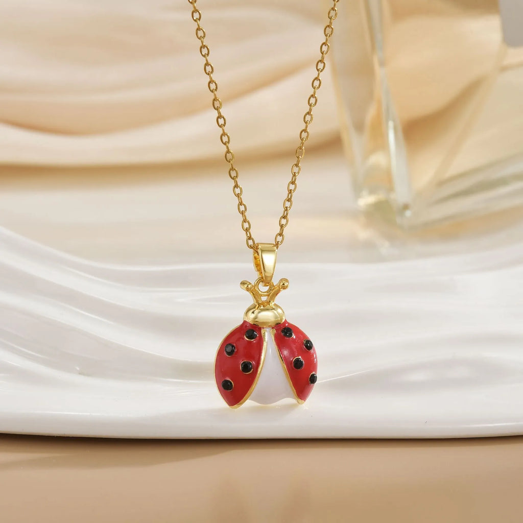 Ladybug pendant necklace with seven-spotted beetle charm, mixed gemstone inlay and copper O-link chain, 41-50cm.