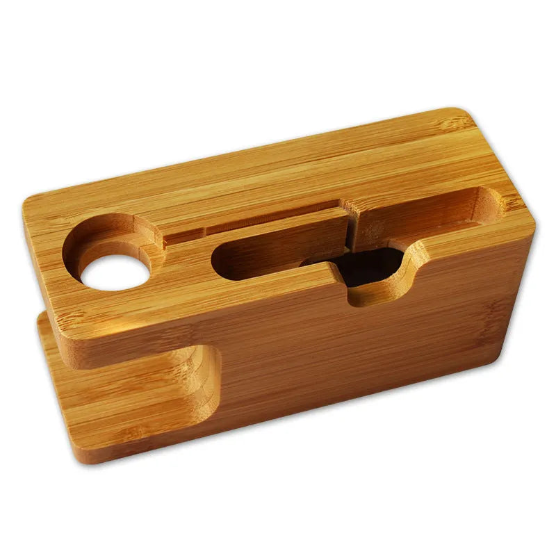 Natural bamboo smartphone stand with carved ornament detail on an office desk.