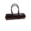 Black corduroy cowhide french stick underarm bag with sewing thread detail on a white background