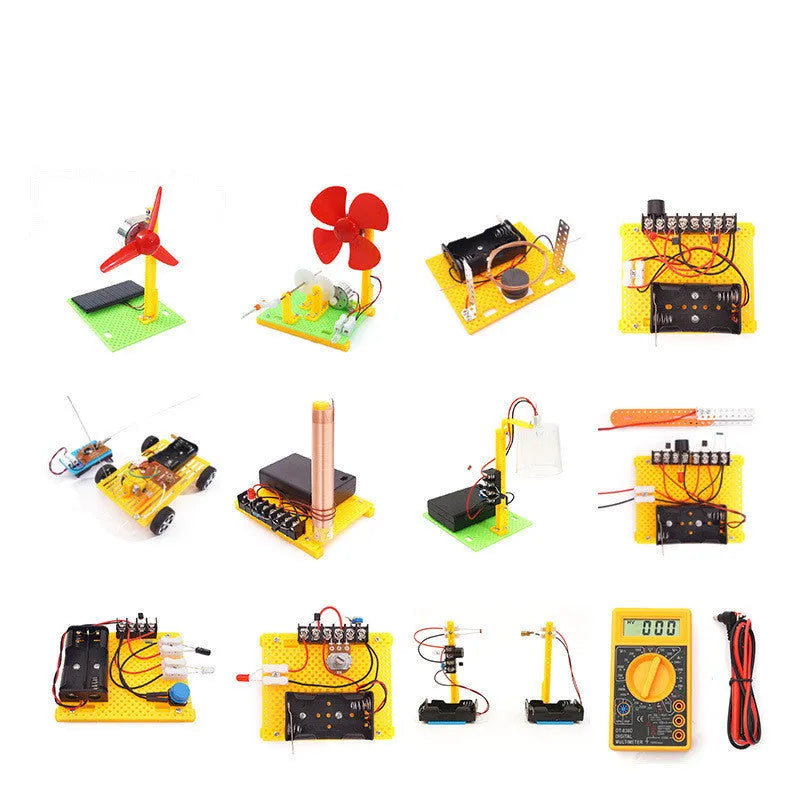 Assembled DIY electronic science set showing a solar fan, hand generator, simple motor, and music doorbell on a table