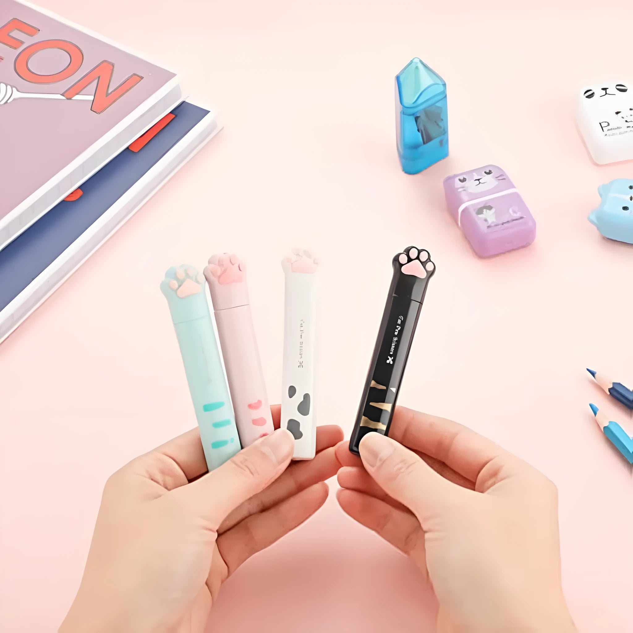 Small folding cat paw mini scissors with stainless steel blade in pink, white, black, and blue colour options.