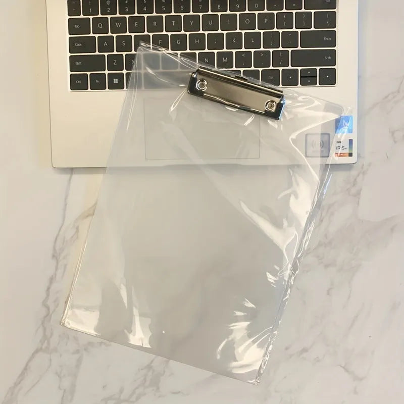Transparent A4 clipboard with metal clip, shown in blue colour on a wooden desk.