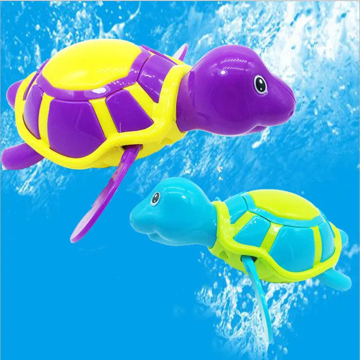 Plastic green turtle baby bath toy floating in water.