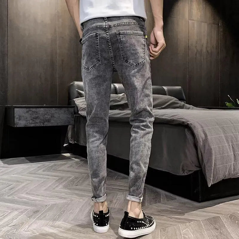 Men's high waist blue jeans with a five-pocket design and button fly on a mannequin.