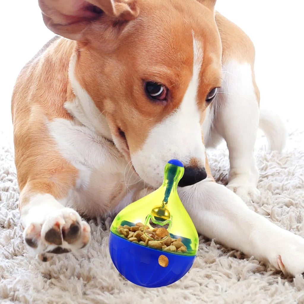 Blue and white tumbler-shaped plastic pet treat dispenser ball on a wooden floor.