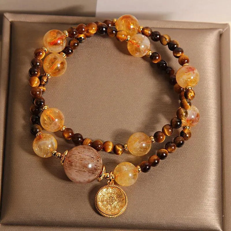 Double circle natural citrine tiger-eye bracelet with yellow tower crystal on white background