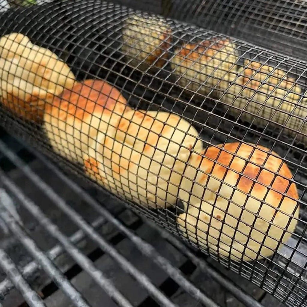 Round rolling metal barbecue grill basket with mesh sides and a handling hook, shown with BBQ gloves.