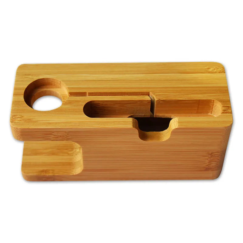 Natural bamboo smartphone stand with carved ornament detail on an office desk.