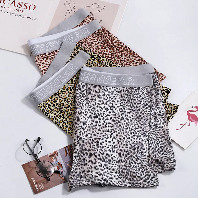 Men's loose fit leopard print boxer shorts showing mid-waist design and polyester knit fabric texture