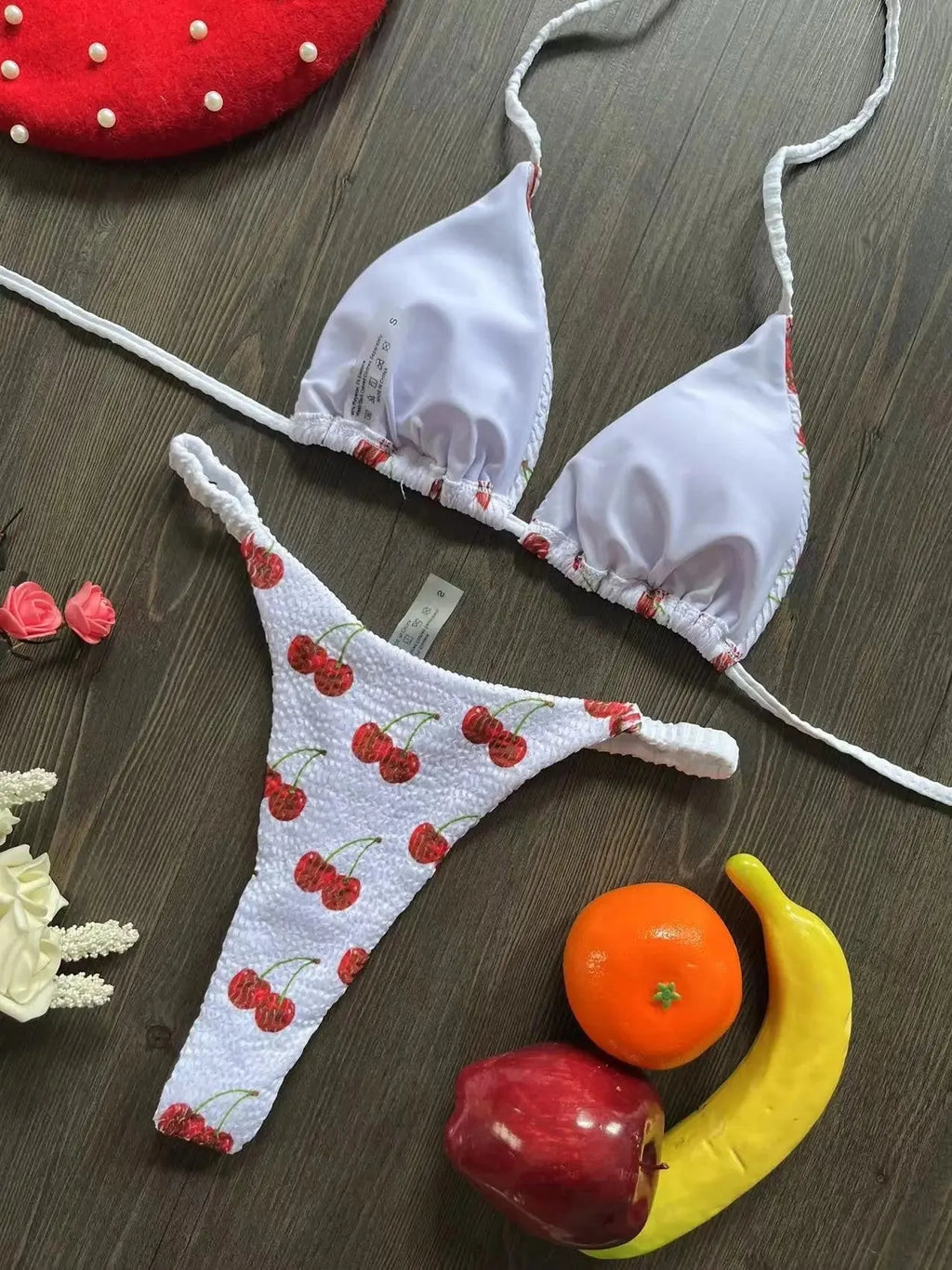 Women's printed bikini swimsuit on a hanger, showing briefs style with quick-drying fabric and cotton lining.