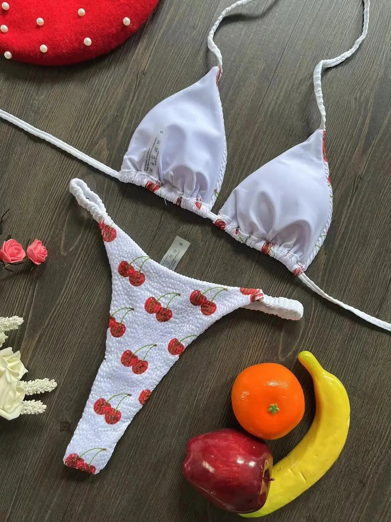 Women's printed bikini swimsuit on a hanger, showing briefs style with quick-drying fabric and cotton lining.