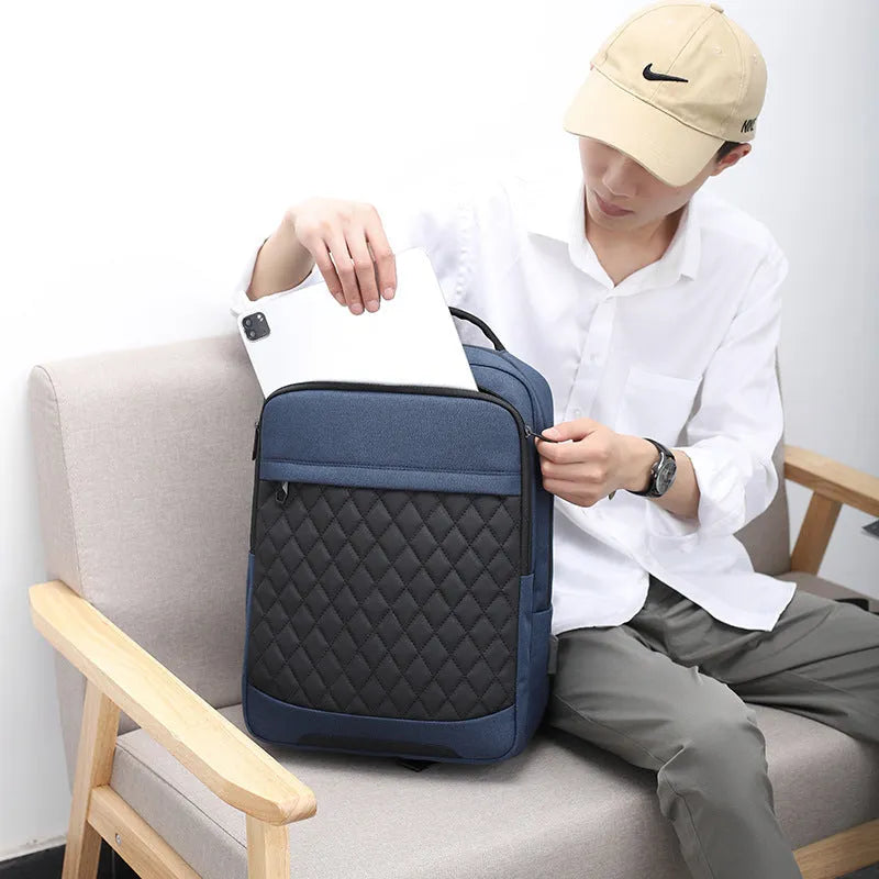 Men's solid colour Oxford cloth travel backpack with curved shoulder strap shown in black, blue, and grey.