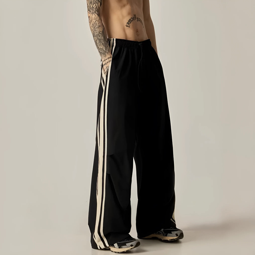 Men's black high-waist wide-leg climbing trousers with straight leg on a plain background.