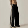 Men's black high-waist wide-leg climbing trousers with straight leg on a plain background.