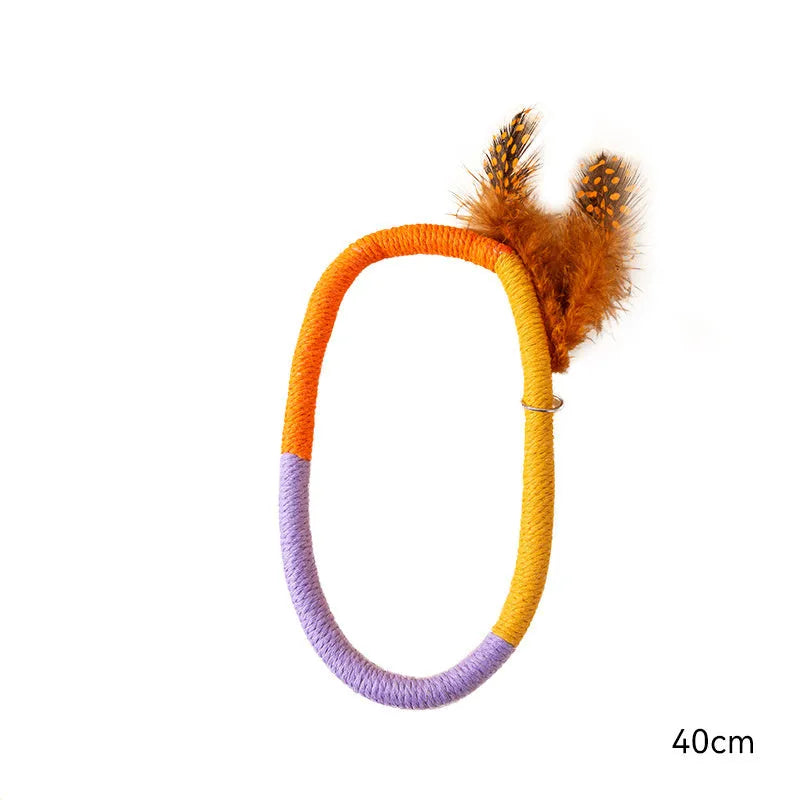 Green circular cotton rope cat toy with feathers and catnip for dental cleaning and interactive play