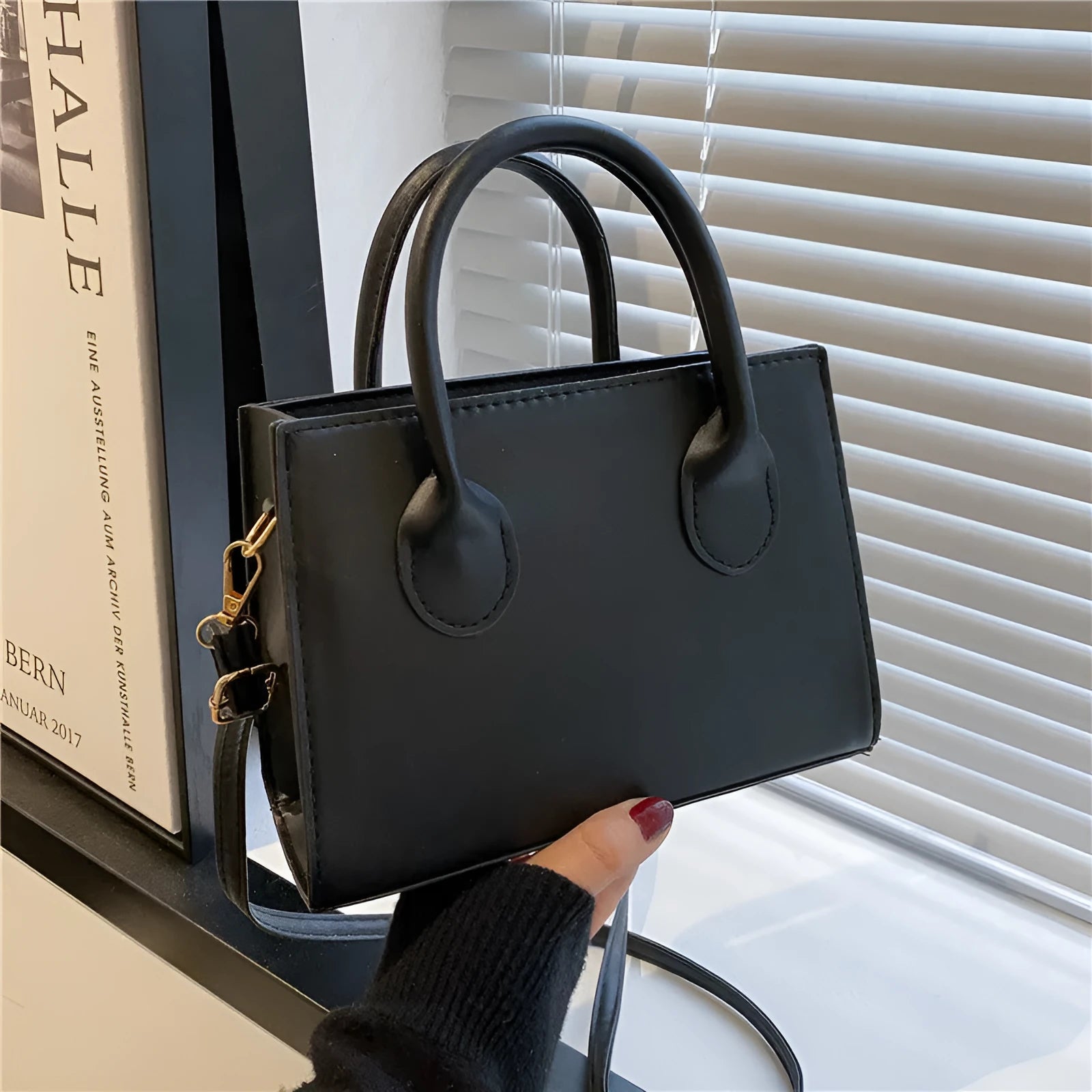 Small square shoulder bag in PU leather with single strap and document pocket, shown in available colours