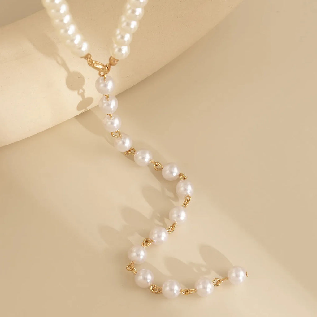 Round bead chain imitation pearl pendant necklace in gold tone with metal construction