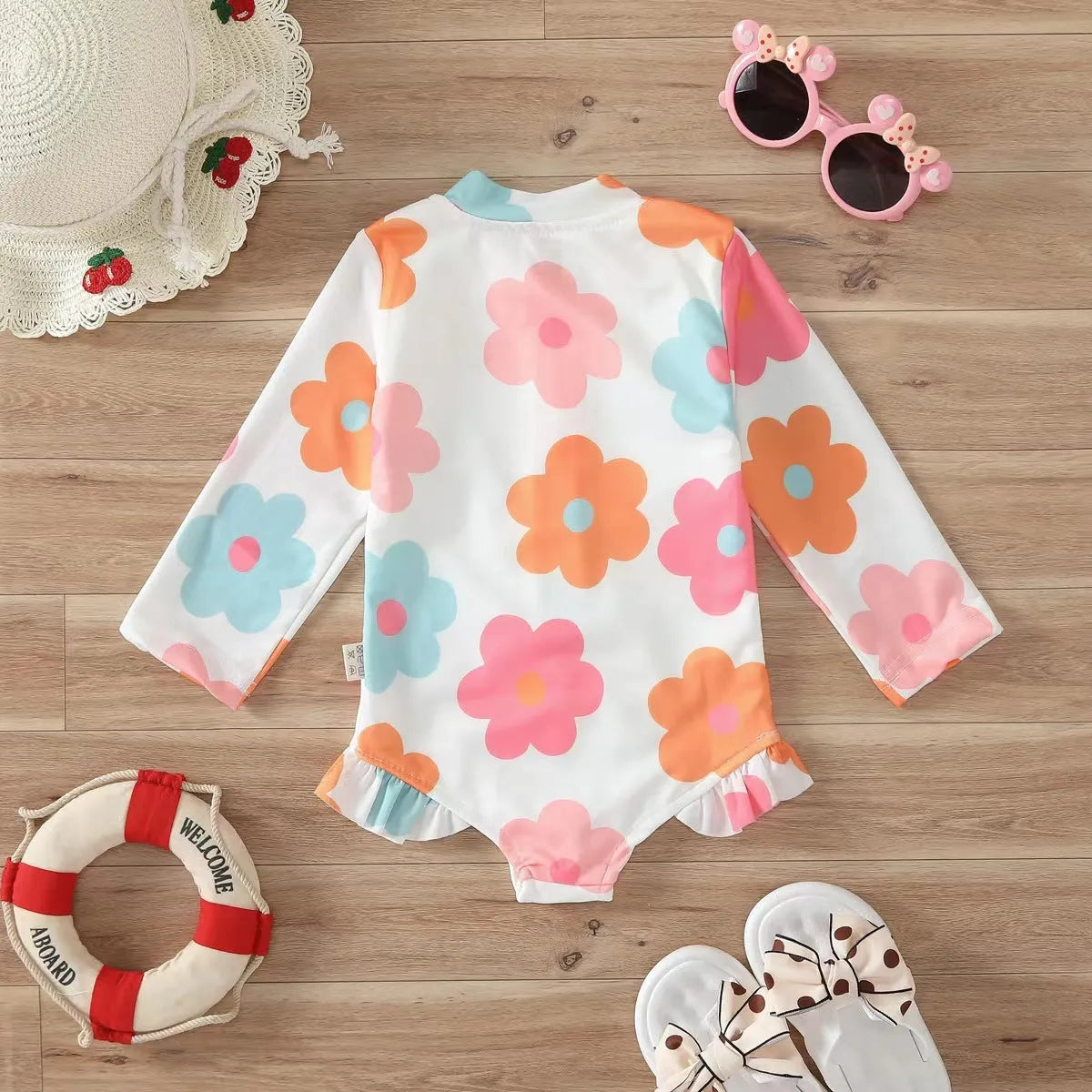 Girls' floral zipper romper swimsuit in pink with front zipper and brief-style bottom
