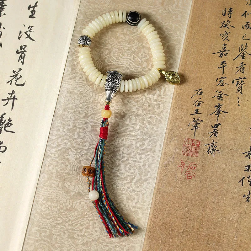 White Bodhi seed bracelet and handheld mala with 3x10mm beads on a neutral background.