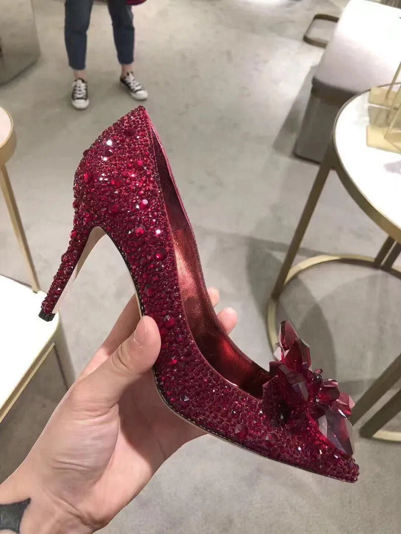 Gold women's pointed toe stiletto heels with sequin and rhinestone decoration on a shallow mouth.