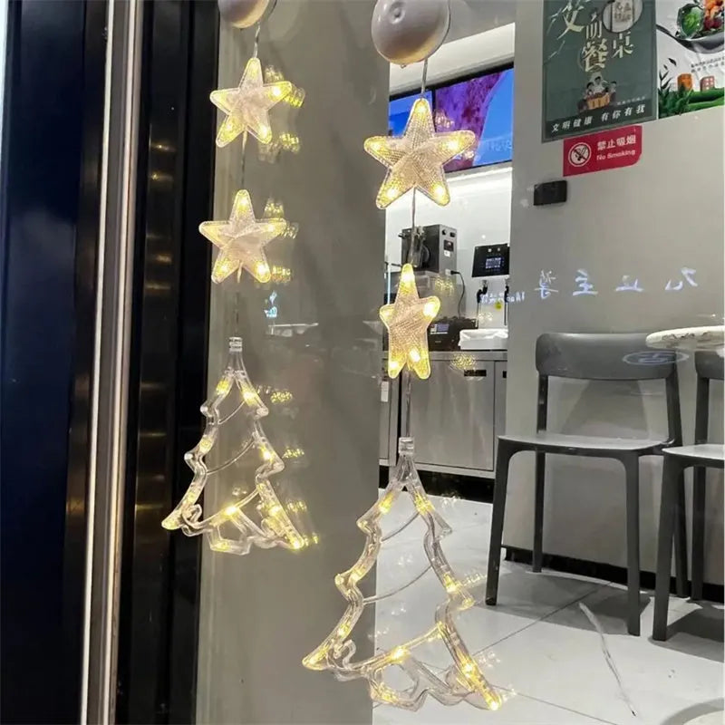 Three Christmas LED pendant lights with suction cups showing star, tree, and snowflake designs