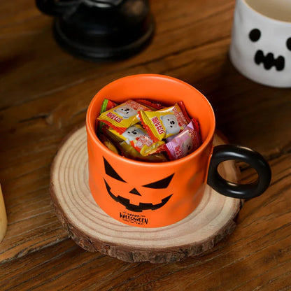 Festive Halloween pumpkin-shaped ceramic mugs in orange and white colors