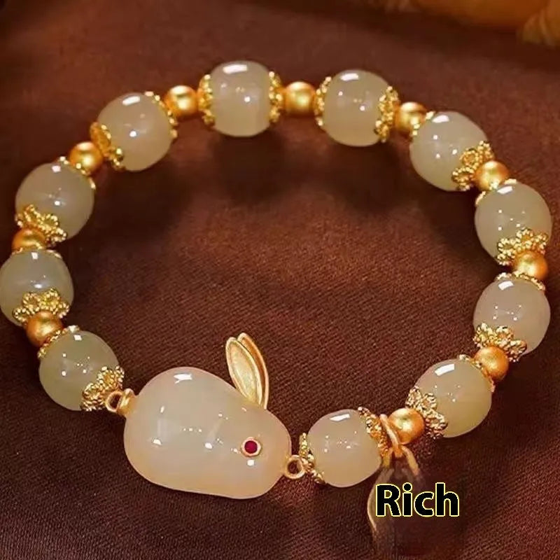 Green electroplated bracelet with a Chinese style hare charm and lily decoration for women.