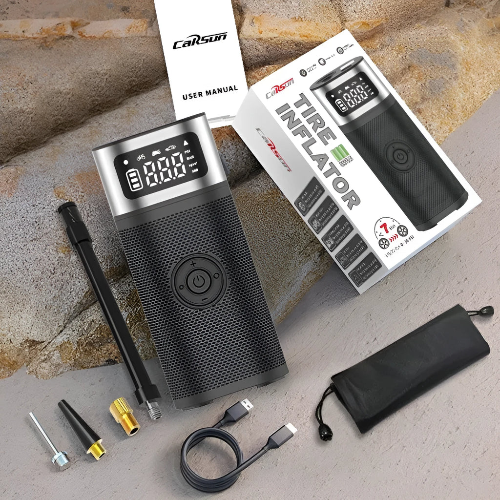 Black portable wireless smart vehicle air pump with USB cable and multiple inflation nozzles on a grey background.