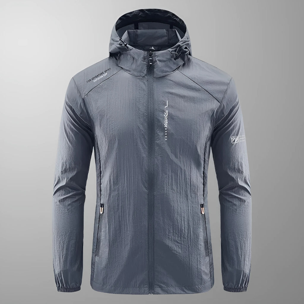 Man wearing a lightweight grey hooded nylon jacket suitable for summer outdoor activities.