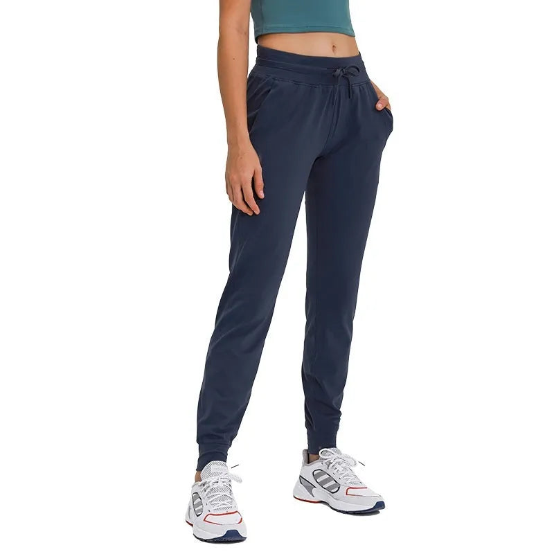 Women's high-waist yoga pants in a cotton blend with a drawstring waist, shown in Belgian Blue colour.