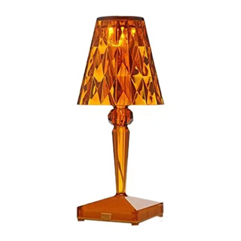 Rose gold portable touch night light on a surface showing its dimmable glow.