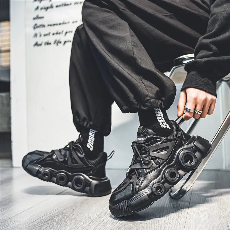 Men's black mesh sneakers with thick rubber soles and round toe design