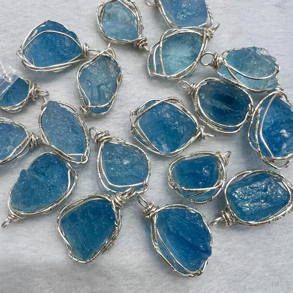 Natural raw aquamarine stone pendant hand-wrapped in gold copper wire with starry sky design