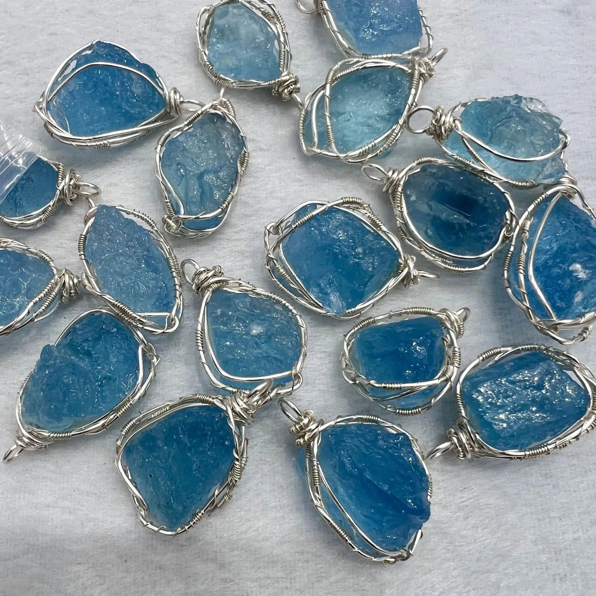Natural raw aquamarine stone pendant hand-wrapped in gold copper wire with starry sky design