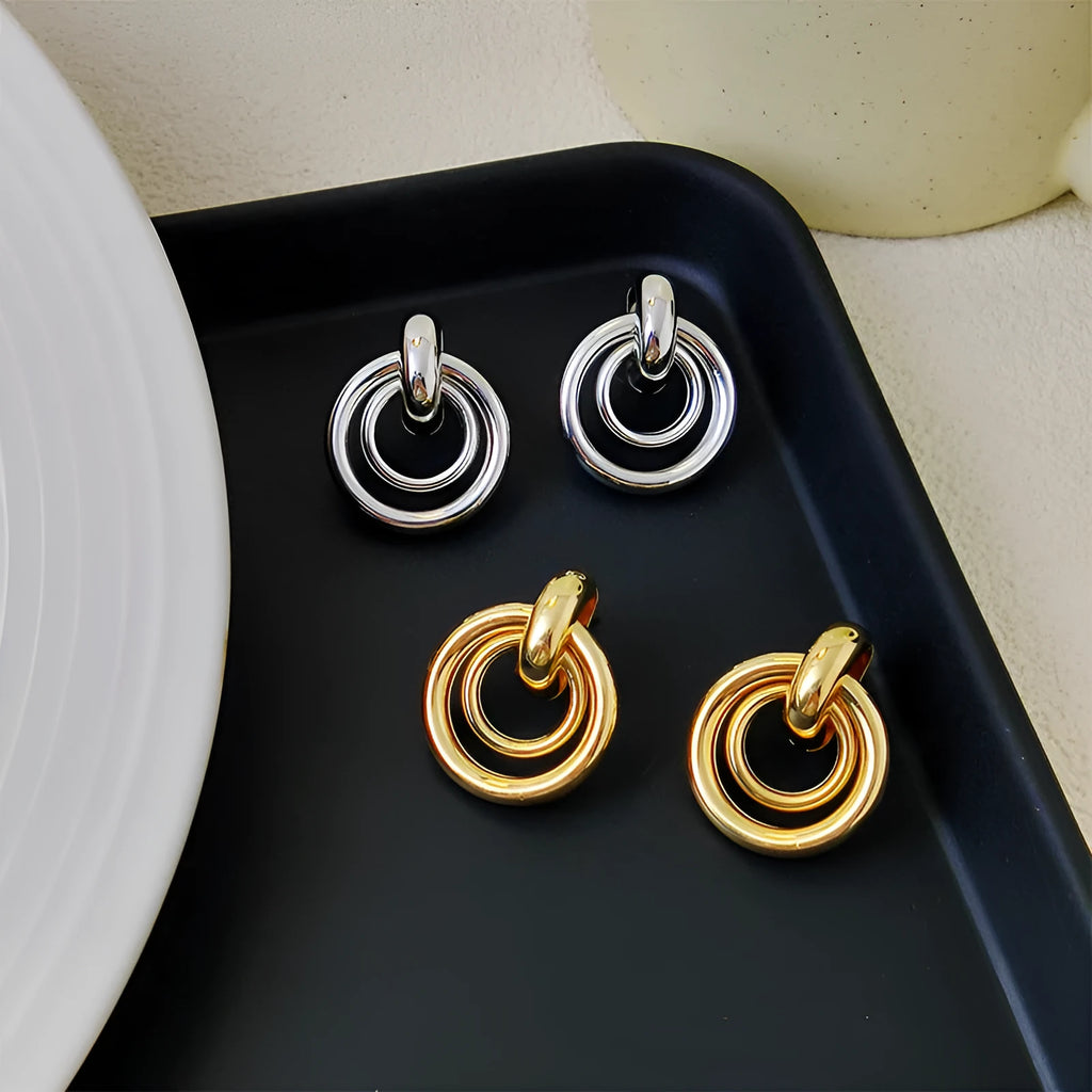 Geometric irregular round ring earrings in electroplated gold colour with exotic style mixed material construction