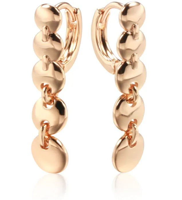 Gold-coloured retro circle earrings with woven copper construction and geometric design